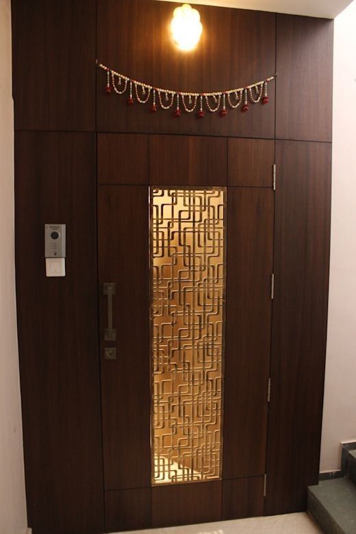 Modern Wood Entry Door with Geometric Metal Inlay and Accent Lighting