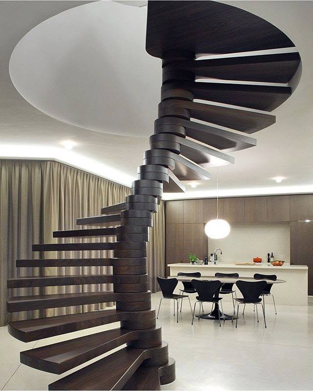 Sculptural Dark Wood Spiral Staircase in a Modern Open-Plan Kitchen