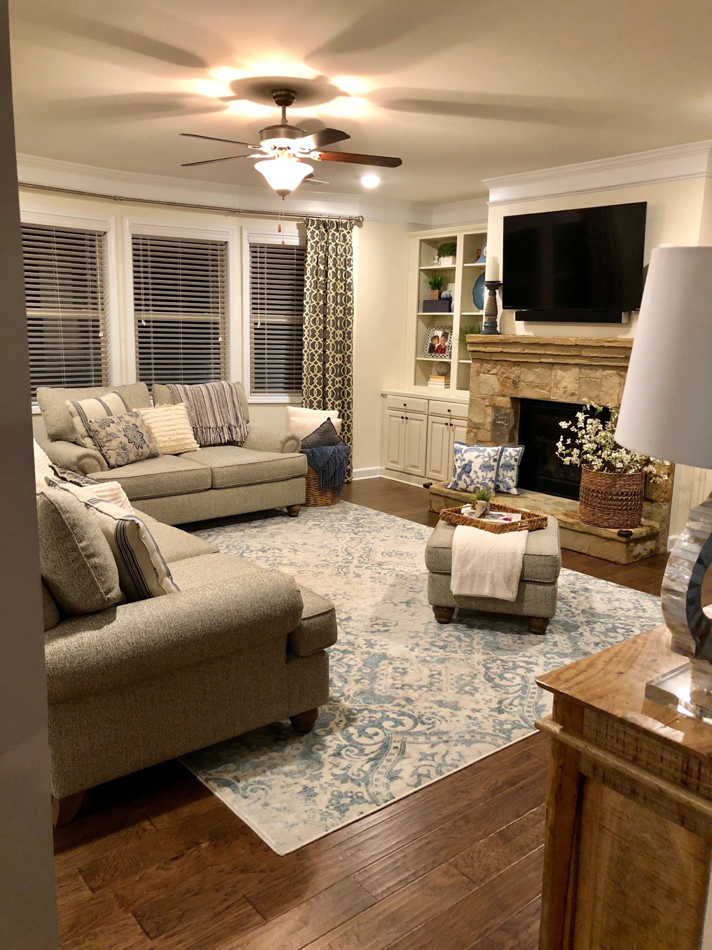 Cozy Living Room with Stone Fireplace and Built-In Shelving